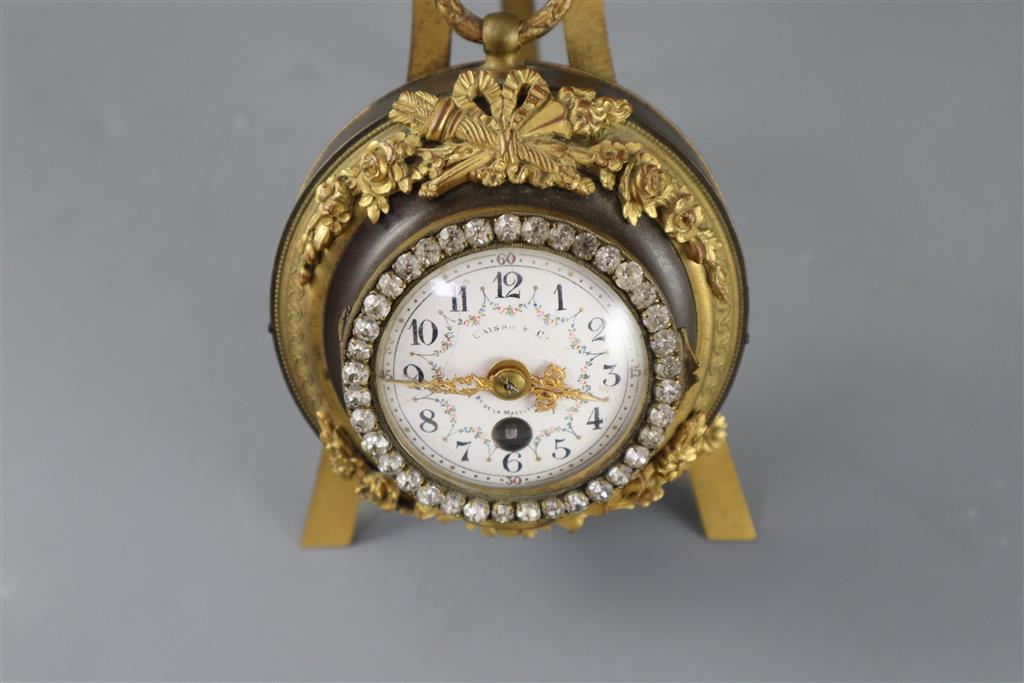 An early 20th century French bronze and ormolu desk timepiece, width 4.5in. overall height 6.25in.